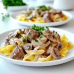 - 2 pounds beef stew meat, cut into cubes - 1 medium onion, chopped - 3 cloves garlic, minced - 8 ounces mushrooms, sliced - 4 cups beef broth - 1 tablespoon Worcestershire sauce - 2 teaspoons paprika - 1 teaspoon dried thyme - 1 tablespoon Dijon mustard - 1 cup sour cream - 3 tablespoons cornstarch - Salt and pepper, to taste - 12 ounces egg noodles - Fresh parsley, chopped (for garnish) In my kitchen, the star of slow cooker beef stroganoff is the beef stew meat. This cut is perfect for slow cooking. It becomes tender and juicy after hours in the slow cooker. Next, I love adding chopped onion and minced garlic. They bring a wonderful aroma to the dish. Sliced mushrooms add a rich umami flavor that rounds out the meal. For liquids, I turn to beef broth and Worcestershire sauce. They provide depth and warmth. Seasonings like paprika and thyme enhance the beef's flavor. A touch of Dijon mustard adds a nice kick. Sour cream gives the dish its creamy texture, while cornstarch helps thicken the sauce. Finally, I serve this dish over egg noodles. They soak up all the delicious sauce. Don't forget to garnish with fresh parsley. It adds a burst of color and freshness. Each ingredient plays a vital role in creating this savory comfort meal. Start by browning the beef stew meat in a large skillet. Heat your skillet over medium heat. Add the beef cubes and cook until they are brown on all sides. This step adds rich flavor. Once browned, transfer the beef to your slow cooker. In the same skillet, add the chopped onion and minced garlic. Cook them for about three to four minutes until they smell great and soften. Then, toss in the sliced mushrooms. Cook these for another two minutes. This makes the mushrooms tender and brings out their taste. Now, transfer this mixture to the slow cooker. Next, pour the beef broth into the slow cooker over the beef and vegetables. Add in Worcestershire sauce, paprika, dried thyme, and Dijon mustard. Stir everything together well. This mix will create a deep, savory flavor for your dish. You can cook your beef stroganoff on low for six to eight hours or on high for three to four hours. Cooking on low gives the beef time to get very tender. Check the beef with a fork. It should break apart easily when it’s done. In the last thirty minutes of cooking, make a cornstarch slurry. Mix three tablespoons of cornstarch with a little water until smooth. Stir this slurry into the slow cooker. This will help thicken the sauce into a creamy delight. Just before serving, remove the lid and stir in one cup of sour cream. Mix until it’s smooth and creamy. Let it heat through for about ten minutes. Meanwhile, cook the egg noodles according to the package instructions. Drain them and set aside. Serve your creamy beef stroganoff over the noodles. Top with chopped fresh parsley for a bright finish. The best cuts for slow cooking are chuck roast or brisket. Both have great flavor and become tender with time. These cuts have enough fat to keep the meat moist. Marbling is key for flavor. It’s the little white lines of fat in the meat. When cooked, this fat melts and adds richness. It also keeps your beef from drying out. To boost flavor, add spices like garlic powder or onion powder. A pinch of cayenne can give a nice kick. You can also try smoked paprika for a deeper taste. Fresh herbs like thyme or parsley can really brighten the dish. Add them just before serving for the best flavor. Beef stroganoff pairs well with egg noodles, but you can get creative! Serve it over rice or mashed potatoes for a change. If you want a lower-carb option, try zucchini noodles or cauliflower rice. Both are tasty and soak up the sauce well. {{image_2}} You can make beef stroganoff healthier. One simple swap is to use Greek yogurt instead of sour cream. Greek yogurt has less fat and more protein. It still gives a creamy texture. You won’t lose flavor, and it adds a nice tang. Another great choice is to use lower-sodium broth. Regular beef broth can be salty. By choosing low-sodium, you control the salt in your dish. This helps keep your meal heart-healthy while still tasting great. If you need gluten-free options, try different noodles. Many brands make gluten-free pasta. You can use rice noodles or even zucchini noodles. They absorb the sauce well and add a fresh twist. Adding more vegetables is a smart way to boost nutrition. Try carrots, bell peppers, or spinach. These veggies add color and nutrients. Plus, they make the dish more filling and tasty. You can adapt this recipe for stovetop or Instant Pot. To cook on the stovetop, follow the same steps but use a large pot. Simmer everything on low heat until the beef is tender. This usually takes about an hour. If you have an Instant Pot, it’s even faster. Brown the meat and sauté the veggies in the pot. Add the liquids and cook on high pressure for about 20 minutes. Let the pressure release naturally for best results. If you don’t have a slow cooker, you can still enjoy this dish. Just follow the stovetop method. You’ll get a delicious meal without needing special equipment. After enjoying your beef stroganoff, let it cool down. Place it in an airtight container. This helps keep the flavors fresh. Store it in the fridge. You can keep it for up to 3 days. If you want to save it longer, freezing is a great option. To freeze beef stroganoff, let it cool completely first. Use freezer-safe bags or containers. Remove excess air to prevent freezer burn. Beef stroganoff can last in the freezer for up to 3 months. When you’re ready to eat, take it out to thaw overnight in the fridge. For reheating, warm it on the stove over low heat. Stir often to prevent sticking. You can also microwave it in short bursts, stirring in between. To refresh leftover stroganoff, add a splash of beef broth or water. This revives the creamy sauce. Heat it gently until warm. Serve it again over fresh egg noodles or rice. Garnish with chopped parsley for a fresh touch. Enjoy your comforting meal all over again! Slow cooker beef stroganoff takes about 6 to 8 hours on the low setting. If you use the high setting, it takes about 3 to 4 hours. The longer cooking time makes the beef tender and full of flavor. Yes, you can cook this recipe on high. However, the texture and flavor may differ. Cooking on high may make the meat less tender. Low cooking allows flavors to meld well and ensures a rich sauce. You can use several substitutes for egg noodles. Consider using zucchini noodles for a low-carb option. For a gluten-free choice, try rice or quinoa. You can also use whole grain pasta for added fiber. You can tell the beef is done when it is tender and easily shreds with a fork. The meat should look brown and juicy. If it still feels tough, let it cook a bit longer. Yes, you can make beef stroganoff ahead of time. Prepare it and store it in the fridge for up to 3 days. Reheat on the stove or in the microwave. The flavors may deepen, making it even tastier! This beef stroganoff recipe combines tender beef, savory vegetables, and rich flavors. You learned to brown the meat, sauté vegetables, and thicken the sauce. Use the tips for enhancing flavor and serving suggestions to make it your own. Experiment with healthy alternatives and different cooking methods to keep it fresh. Remember, leftovers can be stored or frozen for later enjoyment. This dish is versatile, satisfying, and perfect for any occasion. Enjoy your delicious homemade beef stroganoff!