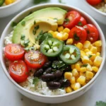 - 2 cups cottage cheese - 1 cup cooked quinoa - 1 bell pepper, diced (any color) - 1 cup cherry tomatoes, halved - 1 avocado, sliced - 1/4 cup corn (fresh or frozen) Cottage cheese is the star here. It packs a punch of protein. Quinoa adds a nice chewy texture and more protein. Fresh vegetables bring color and nutrients. I love adding diced bell pepper for crunch. The cherry tomatoes burst with flavor, while avocado gives creaminess. Corn adds sweetness and pops of color. - 1/2 cup black beans, rinsed and drained - Sliced jalapeños - Fresh cilantro Black beans are a great way to boost fiber and protein. Sliced jalapeños add heat if you like spice. Fresh cilantro gives a burst of freshness and flavor. Feel free to mix and match these optional ingredients to suit your taste. - 2 tablespoons olive oil - Juice of 1 lime - Salt and pepper to taste The dressing is simple but effective. Olive oil gives richness and helps blend flavors. Lime juice adds a refreshing zing. Salt and pepper enhance all the ingredients. You can adjust these to fit your flavor preference. {{ingredient_image_1}} To start, grab a large bowl. Add 2 cups of cottage cheese and 1 cup of cooked quinoa. Mix them well until they blend smoothly. This forms a great base for your power bowl. Next, toss in a diced bell pepper, a cup of halved cherry tomatoes, half a cup of rinsed black beans, and a quarter cup of corn. Lastly, add slices of one avocado for creaminess and flavor. For the dressing, take a small bowl. Whisk together 2 tablespoons of olive oil, the juice of one lime, and a pinch of salt and pepper. This simple mix adds a zesty kick to your bowl. Now, pour the dressing over your cottage cheese and quinoa mix. Gently toss everything together until well coated. This helps every bite burst with flavor. Divide the mixture into serving bowls. For a pop of color and taste, garnish each bowl with chopped fresh cilantro. If you like a spicy kick, add sliced jalapeños on top. Enjoy your fresh and healthy meal! - Selecting ripe avocados: Look for avocados that feel slightly soft when you press them. Avoid hard ones. If they are too soft, they may be overripe. A ripe avocado will add a creamy texture to your power bowl. - Tips for cooking quinoa perfectly: Rinse the quinoa under cold water before cooking. This removes the bitter coating. Use two parts water to one part quinoa. Bring to a boil, then cover and simmer for about 15 minutes. Fluff it with a fork once it’s done. This makes the quinoa light and fluffy. - Preparing ingredients in advance: Cook quinoa and chop vegetables a day before. Keep them in separate containers. This saves time. You can mix them when you are ready to eat. - Storing leftover power bowls: Put leftover bowls in airtight containers. They stay fresh for about three days in the fridge. When you reheat them, add a splash of lime juice for extra flavor. - Adding protein options: Grilled chicken or tofu are great choices. They add flavor and make your meal more filling. You can also try chickpeas for a different taste. - Pairing with side dishes: Serve your power bowl with a light salad or some whole-grain bread. This adds more nutrients and makes your meal more satisfying. Pro Tips Choose the Right Cottage Cheese: Opt for a low-fat or fat-free cottage cheese for a lighter meal, or go full-fat for a creamier texture. Customize Your Veggies: Feel free to swap out the vegetables based on your preference or what’s in season; spinach or kale would be great additions! Add More Protein: To amp up the protein content, consider adding grilled chicken, tofu, or a scoop of your favorite protein powder to the mix. Make It Ahead: This dish can be prepared in advance. Just store the ingredients separately and combine them right before serving to keep everything fresh. {{image_2}} You can easily switch up your power bowls to fit a vegetarian diet. Start by adding different beans and legumes. Chickpeas are a great choice. They add protein and fiber. You can also use lentils for a hearty texture. Next, think about adding leafy greens. Spinach or kale work well here. Just toss them in raw or sauté them lightly. This adds extra nutrients and color to your bowl. For a vegan twist, substitute cottage cheese with dairy-free yogurt. This keeps the creaminess while making it plant-based. Look for brands that are high in protein. Adding nuts and seeds boosts the crunch factor. Try walnuts or pumpkin seeds. They add healthy fats and a nice texture to your meal. Get creative with your flavor profiles! For a Mediterranean bowl, add olives and feta cheese. A drizzle of tahini can enhance the taste too. For a Southwestern flair, consider adding corn and avocado. A sprinkle of taco seasoning can really elevate the flavors. Don't forget about seasonal ingredients. Use ripe tomatoes in summer and roasted squash in fall. This keeps your meals fresh and exciting. You can store leftovers in the fridge for up to three days. To keep them fresh, use an airtight container. This helps prevent them from drying out or absorbing other smells. Always check for any sign of spoilage before eating. If the cottage cheese looks or smells off, it’s best to throw it away. Yes, you can freeze cottage cheese power bowls! However, the texture may change once thawed. To freeze, place the bowls in freezer-safe containers. Make sure to leave some space at the top for expansion. When you’re ready to eat, thaw them in the fridge overnight. Reheat in the microwave or a pan until warm. Get creative with your leftover bowls! You can turn them into a breakfast burrito. Just wrap the mix in a tortilla with some scrambled eggs. Or, add them to a soup for extra protein. You can also blend the leftovers into a creamy dip. This way, you can enjoy them in new and tasty ways! Cottage cheese offers many health benefits. It is high in protein, which helps build muscle. It contains calcium for strong bones. Cottage cheese is low in fat and calories, making it great for weight control. It also has probiotics, which support gut health. Each serving gives you essential nutrients, like B vitamins and phosphorus. Overall, cottage cheese is a smart choice for a healthy diet. Yes, you can make these power bowls ahead of time. Meal prepping saves time and keeps you on track. Start by cooking the quinoa and chopping veggies. Store each ingredient separately in airtight containers. When ready to eat, just mix them with cottage cheese. You can keep the bowls in the fridge for up to three days. This way, you can enjoy a healthy meal anytime. If you don’t have quinoa, try other grains. Brown rice is a great substitute. It has a nice texture and is filling. Bulgur wheat is another option. It cooks quickly and adds flavor. You can also use farro or barley for a hearty bite. Each grain offers its own taste and benefits, so feel free to mix it up! In this guide, I detailed how to create delicious cottage cheese power bowls. We covered main ingredients like quinoa and fresh veggies, plus optional ones that boost flavor. You learned how to mix a simple dressing and assemble your bowl. I also shared tips for choosing the best ingredients and meal prep methods. These bowls are flexible, and you can swap in seasonal items to keep it fun. Enjoy experimenting with your own combinations! Keep this guide handy for quick, tasty meals.