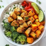 - 2 boneless chicken breasts, cubed - 1 large sweet potato, peeled and diced - 1 cup jasmine rice Chicken is the star of this dish. I use boneless breasts for ease. They cook fast and stay juicy. Sweet potatoes add a natural sweetness and nice texture. Jasmine rice provides a fluffy base that pairs well with the other flavors. - 2 tablespoons olive oil - 1 teaspoon smoked paprika - 1 teaspoon garlic powder - 1 teaspoon onion powder - Salt and pepper to taste Olive oil helps the chicken and veggies cook evenly. The spices bring the dish to life. Smoked paprika adds a warm flavor, while garlic and onion powders give a savory kick. Salt and pepper enhance all the flavors. - Fresh parsley, chopped for garnish - Lime wedges for serving Garnishes make your bowl look appealing. Fresh parsley adds color and a fresh taste. Lime wedges bring brightness to every bite. Squeeze some lime over your bowl for a zesty finish. {{ingredient_image_1}} First, turn on your oven to 400°F (200°C). This step helps the sweet potatoes cook evenly. Next, peel and dice one large sweet potato. In a bowl, mix the sweet potato with one tablespoon of olive oil. Add one teaspoon of smoked paprika, one teaspoon of garlic powder, one teaspoon of onion powder, salt, and pepper. Toss everything until the sweet potato pieces are well coated. Spread them on a baking sheet lined with parchment paper. Roast for 20-25 minutes. The sweet potatoes should be tender and slightly crispy. While the sweet potatoes roast, rinse one cup of jasmine rice under cold water. This step removes excess starch. In a medium pot, bring two cups of vegetable broth to a boil. Add the rinsed rice to the pot. Lower the heat, cover, and let it simmer for 15 minutes. The liquid should absorb fully. After that, remove the pot from heat and let it sit for another 5 minutes, still covered. In a large skillet, heat one tablespoon of olive oil over medium-high heat. Add two cubed boneless chicken breasts. Cook for 5-7 minutes, stirring often, until the chicken turns white and reaches 165°F (75°C). Add salt and pepper to taste. Once the chicken is cooked, add one sliced red bell pepper and one cup of broccoli florets to the skillet. Cook for another 3-5 minutes. The vegetables should become tender but still crisp. Now you're ready to assemble your delicious chicken and sweet potato rice bowls! - Ensuring Chicken is Cooked Through: To check if chicken is done, use a meat thermometer. It should read 165°F (75°C). This ensures it is safe to eat. Cut into a piece if unsure. No pink means it's ready! - Alternative Cooking Methods: You can grill, bake, or pan-fry the chicken. Each method gives a different taste and texture. Grilling adds a smoky flavor, while baking keeps it juicy. Choose what you like best! - Achieving Optimal Crispiness: Cut sweet potatoes into small, even pieces. This helps them roast evenly. Spread them out on the baking sheet. Avoid crowding so they get crispy. - Seasoning Variations: Feel free to mix up the spices! Try adding cinnamon for sweetness or cayenne for heat. Lemon zest can add a fresh touch. Experiment to find your favorite blend! - Common Mistakes to Avoid: Rinsing the rice is key. It removes excess starch that can make it sticky. Always use the right water-to-rice ratio for best results. Too much water makes mushy rice. - Using Broth vs. Water: Cooking rice in vegetable broth adds flavor. It makes the rice taste richer and more savory. If you prefer plain rice, water works too. Just season it with salt after cooking. Pro Tips Use Fresh Ingredients: Always opt for fresh vegetables and high-quality chicken to enhance the flavors of your dish. Customize the Spices: Feel free to adjust the spices based on your palate; adding a pinch of cayenne can give it an extra kick! Meal Prep Friendly: This recipe is great for meal prep; you can store bowls in the fridge for up to 4 days. Experiment with Toppings: Top your rice bowls with avocado, nuts, or a dollop of Greek yogurt for added creaminess and flavor. {{image_2}} You can switch up the protein in your Chicken and Sweet Potato Rice Bowls. If you want a meat-free option, try tofu or tempeh. Both soak up flavors well and add a nice texture. Just cube them and cook until golden brown. If you prefer seafood, shrimp works great too. Just sauté shrimp for a few minutes until they turn pink. You can also use beef. Thinly slice it and cook it quickly for a tasty twist. Feel free to get creative with your veggies! You can add zucchini, carrots, or even spinach. These will add color and nutrients. Think about using seasonal veggies too. In summer, fresh corn is a sweet addition. In fall, try butternut squash for a warm flavor. To change the taste, add different sauces or marinades. A splash of soy sauce or teriyaki can add a savory kick. For a citrus twist, drizzle on some lime juice. If you like heat, add chili flakes or sriracha. For a milder dish, skip the spices and focus on herbs like basil or cilantro. This way, you can make each bowl unique! To keep your chicken and sweet potato rice bowls fresh, follow these steps: - Place leftovers in an airtight container. - Store them in the fridge for up to 3 days. - Make sure the food cools to room temperature before sealing. For longer storage, you can freeze them: - Use freezer-safe containers or heavy-duty bags. - Be sure to label the bags with the date. - Store in the freezer for up to 3 months. To enjoy your meal again, reheating is key. Here’s how you can do it: - Microwave: Place a portion in a microwave-safe dish. Cover it with a lid or a damp paper towel. Heat for 1-2 minutes until warm. - Stovetop: Heat in a skillet over medium heat. Stir occasionally until heated through. This helps keep the texture nice. Avoid reheating more than once to keep it safe and tasty. Understanding shelf life helps you enjoy your meals at their best. - Cooked chicken lasts about 3-4 days in the fridge. - Sweet potatoes are good for about 5 days after cooking. - Jasmine rice can last about a week in the fridge. Check for signs of spoilage: - Look for bad smells or changes in color. - If it feels slimy or mushy, it’s time to toss it. You can make this dish low-carb by using cauliflower rice. Cauliflower rice mimics the texture of regular rice well. Simply pulse fresh or frozen cauliflower florets in a food processor until they resemble rice grains. Sauté it in a pan with a little olive oil for about 5-7 minutes. This keeps the dish light and delicious. Yes, you can use brown rice. However, brown rice takes longer to cook than jasmine rice. You will need to increase the cooking time to about 40-45 minutes. Use 2 ½ cups of vegetable broth instead of 2 cups. This ensures the brown rice cooks well and absorbs enough liquid. You can serve a simple green salad with this dish. A salad with mixed greens, cucumbers, and a light vinaigrette pairs well. Roasted vegetables can also be a great side. Consider making some roasted Brussels sprouts or green beans for added flavor. This article covered a tasty chicken and sweet potato rice bowl recipe. We discussed main ingredients, seasonings, and step-by-step cooking methods. Plus, I shared tips for perfect results and variations to try. In the end, this dish is versatile and easy to customize. You can swap proteins or vegetables based on your taste or diet. Enjoy your cooking and have fun creating your own versions!